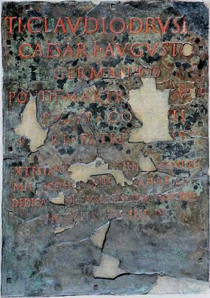 Herculaneum Augusteum. Dedicatory inscription to Claudius, found on 27.12.1741. 
Now in Naples Archaeological Museum. Inventory number 3839.
The tablet refers to the bronze statue of Claudius (MANN 5593)
The inscription reads:

Ti Claudio Drusi f.
Caesari Augusto
Germanico
pontif(ici) max(imo) tri[b(icia) po]t(estate) VIII
i[m]p(eratori) XVI co(n)
s(uli) [I]III
patri patria[e ce]ns(ori) 
ex testame[nto] [- -essi L. f. M[e]n Senec[a]e
milit(is) cohor(tis) XIII urbanae et
dedicazioni eius legavit municipib(us)
singulis (sestertios) IIII n(ummos)      [CIL X 1416]

According to Cooley this translates as:

To Tiberius Claudius Caesar Augustus Germanicus, son of Drusus, supreme pontiff, holder of tribunician power for the eighth time, hailed victorious commander sixteen times, consul four times, father of the fatherland, censor, in accordance with the will of [?]essius Seneca, son of Lucius, of the Menenian voting tribe, soldier of the thirteenth urban cohort, and at its dedication he bequeathed to the townsmen 4 sesterces each.      [CIL X 1416]

See Cooley, A. and M.G.L., 2014. Pompeii and Herculaneum: A Sourcebook. London: Routledge, p. 206, F140b.

