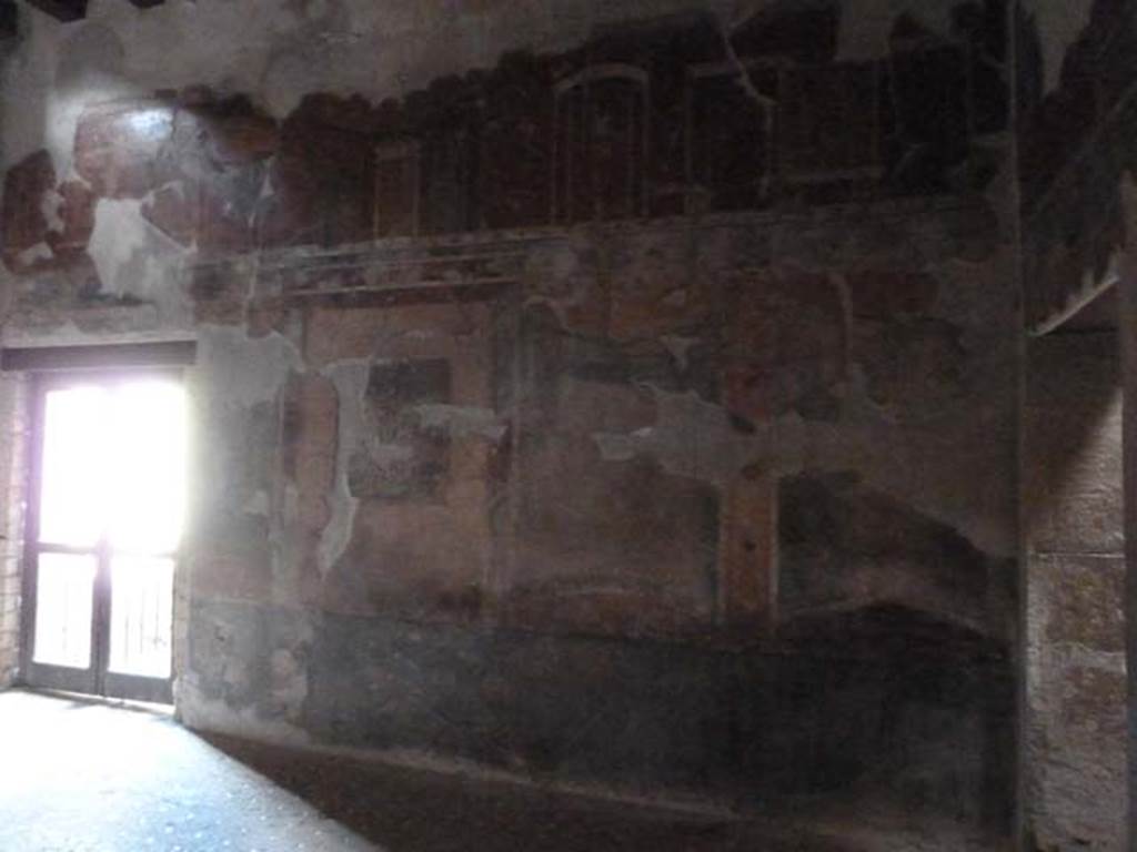 III.11 Herculaneum. May 2010. Room 8, north wall with doorway to east portico, on left.
The doorway on the right, leads back into the atrium. 
