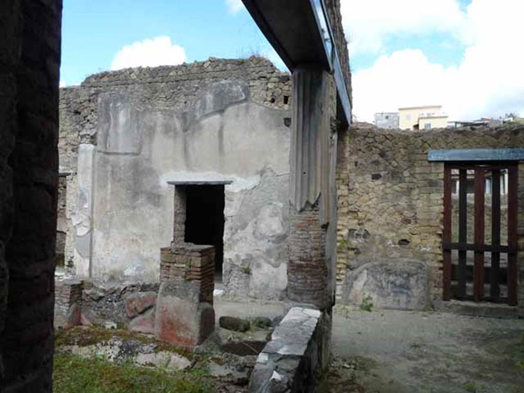 III.11 Herculaneum. May 2010. Looking north across the garden peristyle, towards doorway to room 12, on left.
Taken from doorway in north wall of room 8. 
