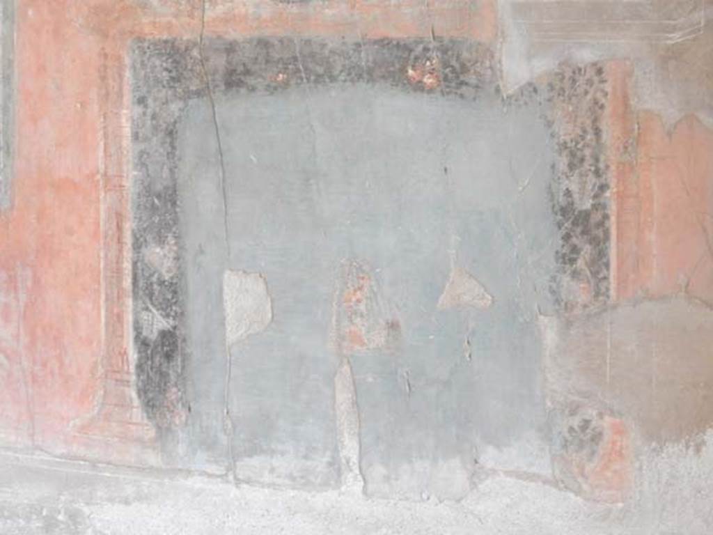 IV.21, Herculaneum. May 2018. Triclinium 5, detail of blue painted panel of masks, very badly faded, and left in situ.
Photo courtesy of Buzz Ferebee. 
