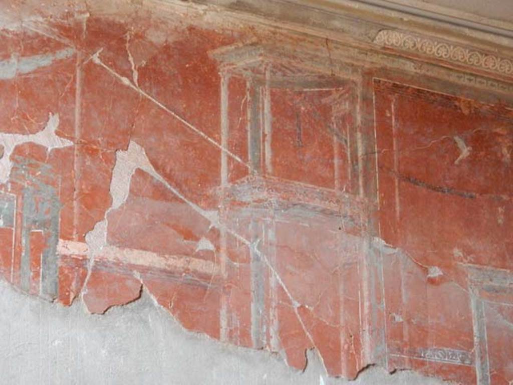 IV.21, Herculaneum. May 2018. Oecus 7, detail of painted decoration from centre of upper west wall.
Photo courtesy of Buzz Ferebee. 
