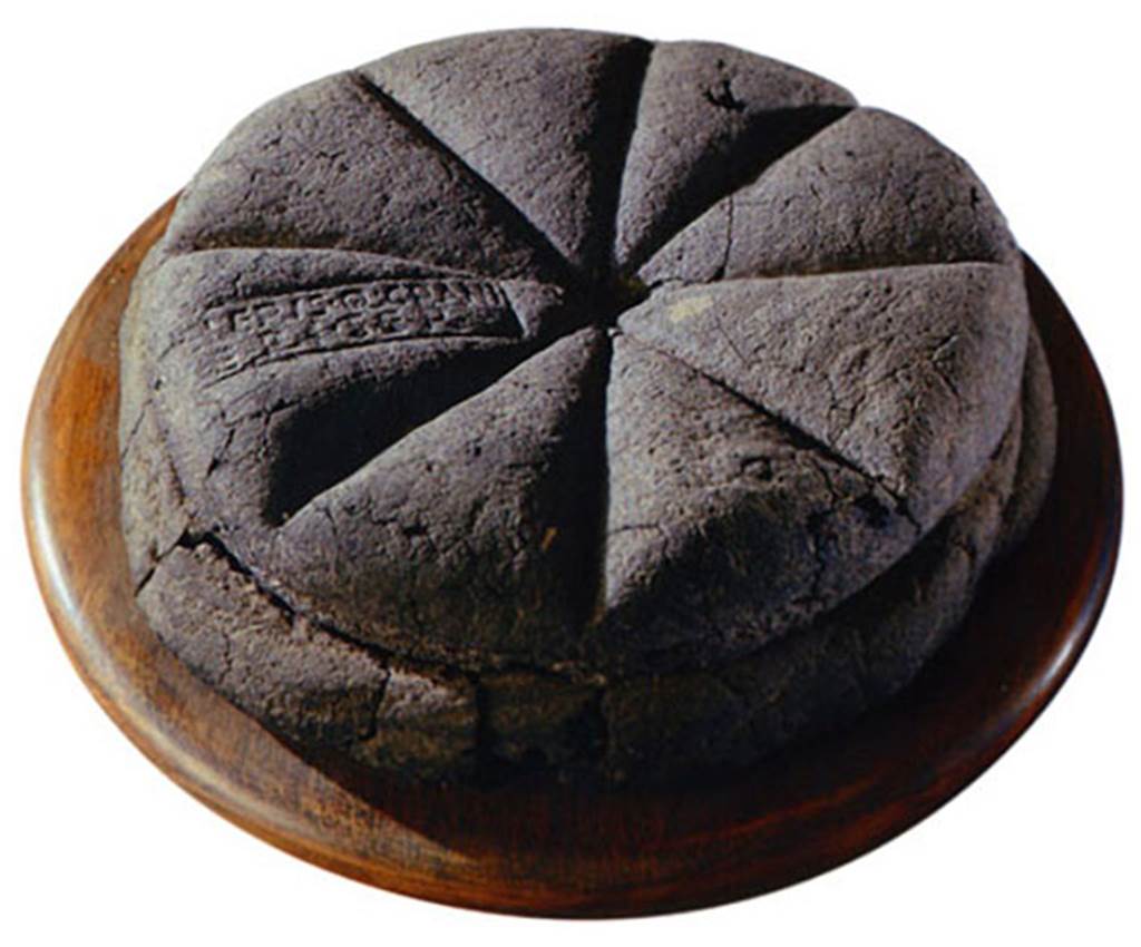 IV.21, Herculaneum. Uncut loaf of carbonised bread with stamped inscription. The loaf of bread had a stamp �Property of Celer, slave of Q. Granius Verus�.
See Wallace-Hadrill, A. (2011). Herculaneum, Past and Future. London, Frances Lincoln Ltd., (p.242-244).
According to Pagano and Prisciandaro on 5th October 1748, an entire loaf of carbonised bread was found, with a mark that contained these letters �
[C]eleris Q(uinti) Grani
Veri ser(vi)    - CIL X 8058,18
Now in Naples Archaeological Museum, inventory number 84596.
See Pagano, M. and Prisciandaro, R., 2006. Studio sulle provenienze degli oggetti rinvenuti negli scavi borbonici del regno di Napoli.  Naples: Nicola Longobardi. (p.205)
The footnote 163 states, see also the seal found 15th May 1755, CIL X 8058,18, �belonging to Celer, slave of Q. Granius Verus�.  The seal actually in the Antiquarium Comunale of Celio at Rome). 

