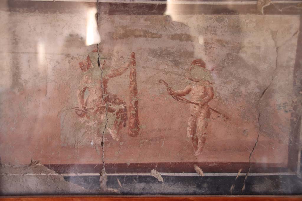 IV.21, Herculaneum. September 2019. Cryptoporticus 28, detail of cupid painting from east end of north wall.
Photo courtesy of Klaus Heese.  
