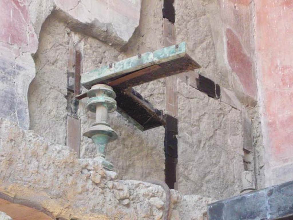V 7/6, Herculaneum, August 2013. Upper room c, detail of remains of foot of bronze bed. Photo courtesy of Buzz Ferebee.

