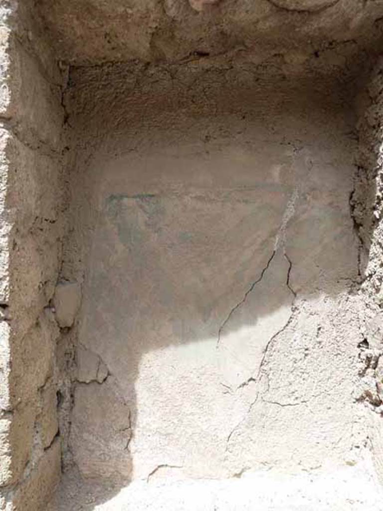 V. 10, Herculaneum, May 2010. Detail of niche in west wall of shop-room. 