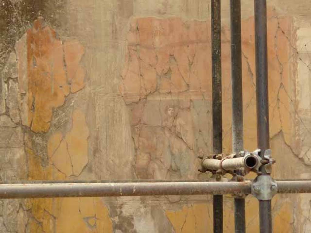 V.11 Herculaneum. May 2010. Looking towards south wall of tablinum. 
The central wall painting on the south wall was Apollo Citaredo or Apollo, the Lyre-Player.
This painting showed Apollo playing a lyre and crowned with laurel; a nymph, and on one side, a cupid supports the god�s heavy quiver.


