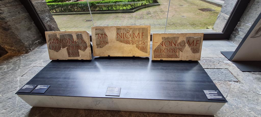 Herculaneum. April 2023. 
Inscriptions dedicated to Marcus Nonius Balbus, on display in “Campania Romana” gallery of Naples Archaeological Museum. 
Inv. 3732 on left, inv. 3734 in centre, and inv. 3736 on right.  Photo courtesy of Giuseppe Ciaramella.

On left: - Dedication to Marcus Nonius Balbus by the inhabitants of Cnossus
Ercolano (Napoli), ignoratur (nel foro?) 
M(arco) Nonio M(arci) [f(ilio)]
Balbo, pr(aetori), pro c[o(n)s(uli)]
[coloni]a Iulia C̣[nossus].

In centre: - Dedication to Marcus Nonius Balbus by the inhabitants of Crete
Ercolano (Napoli), ignoratur (nel foro?) 
M(arco) N[o]nio M(arci) f(ilio) 
Bal[bo], p̣r(aetori), pro co(n)s(uli), 
[commune Creten]sium.      [CIL X, 1431]

On right: - Dedication to Marcus Nonius Balbus by the inhabitants of Gortyniei
Ercolano (Napoli), ignoratur (nel foro?) 
[M(arco)] Nonio M(arci) f(ilio) 
Ḅalbo, pr(aetori), prọ [c]o(n)s(uli),
[G]ortyniei aẹ[re conl(ato)].       [CIL X, 1434]

