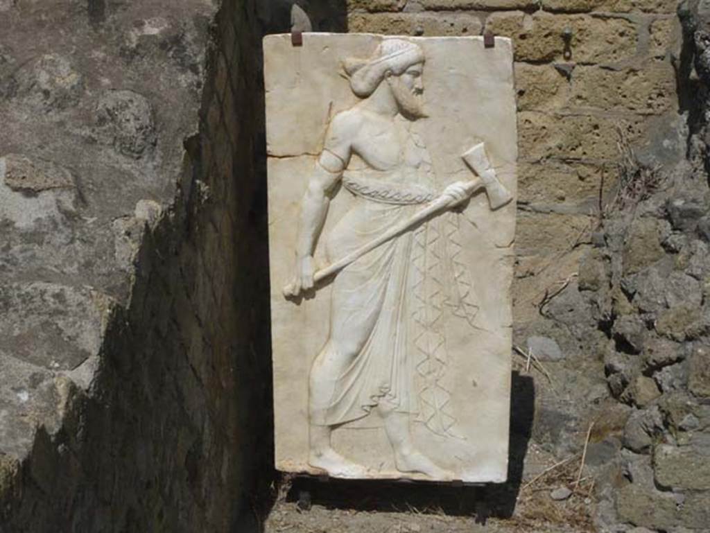 Herculaneum, August 2013. Sacred Area terrace, the shrine of Four Gods. Reproduction relief of Vulcan. Photo courtesy of Buzz Ferebee.