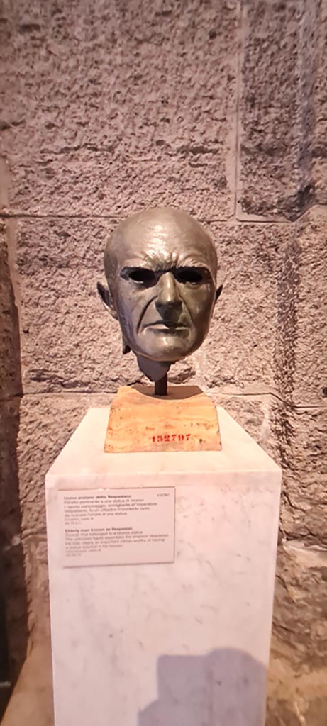 Herculaneum. Cardo III. April 2023.  
Part of a statue of an unknown elderly man resembling the Emperor Vespasian.
He was clearly an important citizen worthy of having a statue erected in his honour.
On displayed in “Campania Romana” gallery of Naples Archaeological Museum, inv. no. 152797.
Photo courtesy of Giuseppe Ciaramella.

