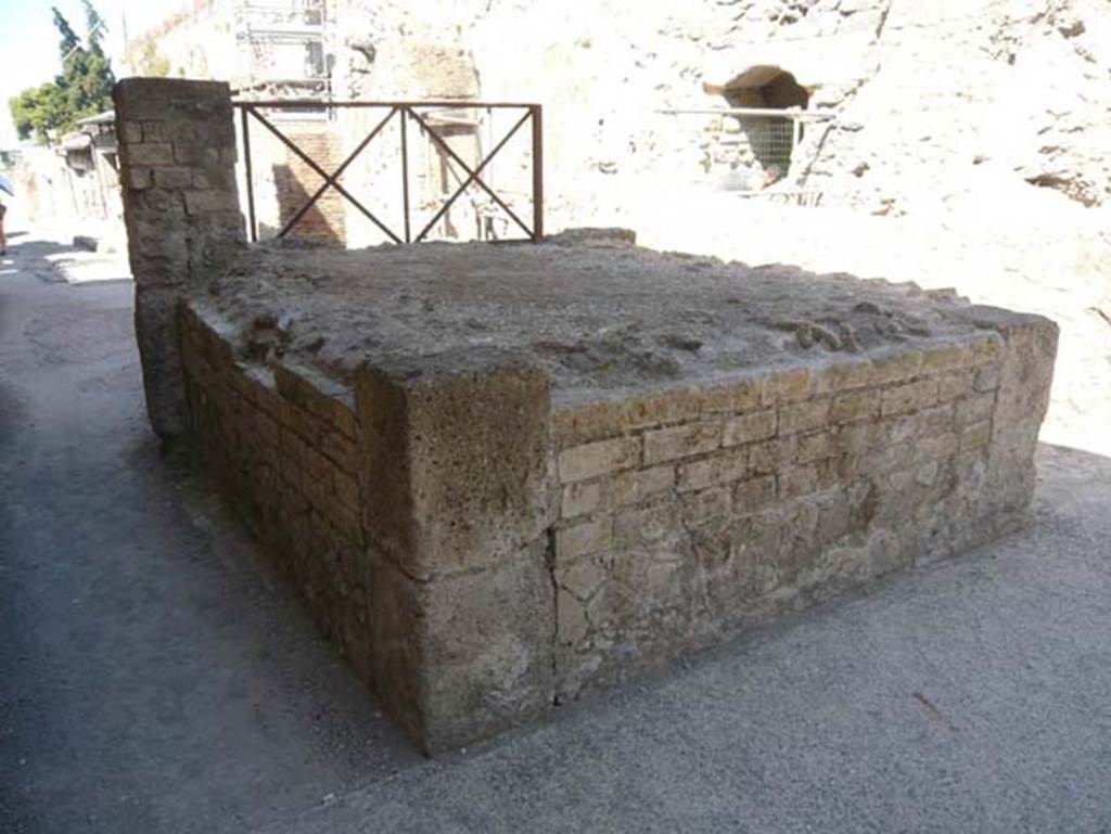 Cardo III Superiore, Herculaneum. August 2013. 
Looking south from rear east side of rectangular structure with steps. Photo courtesy of Buzz Ferebee.
According to Wallace-Hadrill, “No wagons or carts carrying supplies to shops and private houses could pass here. 
Even Cardo III was end-stopped. A rectangular structure, a little over a metre high, stands in the way of traffic.
Its function is not obvious. 
It has been identified as a tribunal, or suggestum, from which a magistrate could address the people, or a public crier could make an announcement.
An alternative would be to see it as a base of a small shrine.”
See Wallace-Hadrill, A., 2011. Herculaneum Past and Future. London: Frances Lincoln, (p.177).
