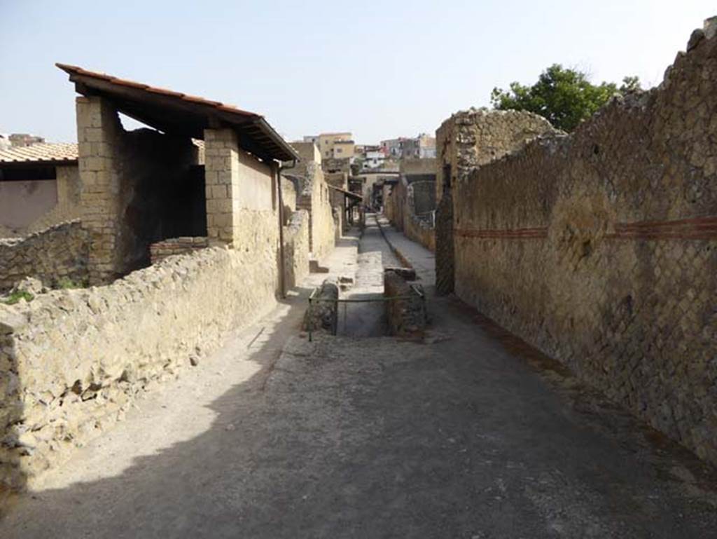 III.19/18/1, on left, Herculaneum, October 2014. Looking north along Cardo IV Inferiore. Photo courtesy of Michael Binns.
