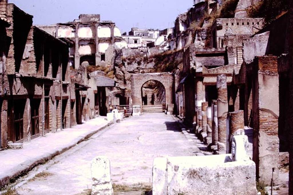 Looking west along Ins V. on Decumanus Maximus, Herculaneum. 1975. Photo by Stanley A. Jashemski.   
Source: The Wilhelmina and Stanley A. Jashemski archive in the University of Maryland Library, Special Collections (See collection page) and made available under the Creative Commons Attribution-Non Commercial License v.4. See Licence and use details. J75f0709

