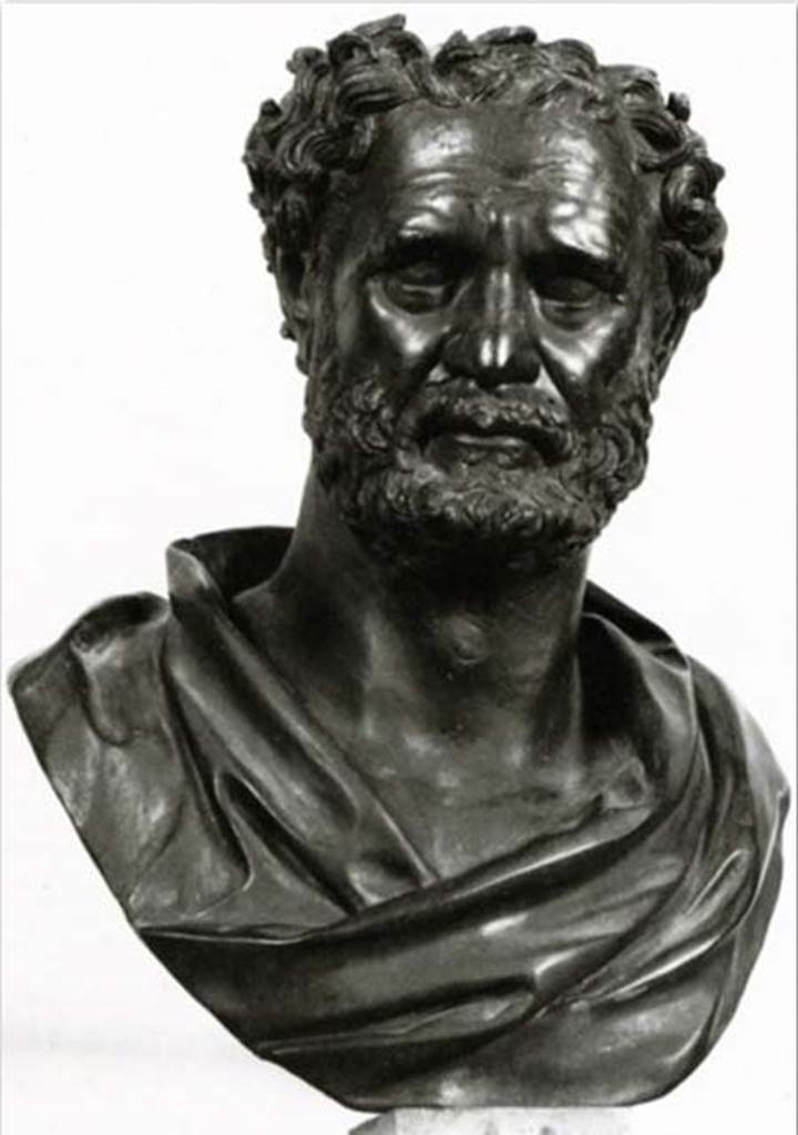 Villa dei Papiri, Herculaneum. Bust of Empedocles of Agrigento or Heraclitus. Found in 1753 in the angles of the peristyle.
Now in Naples Archaeological Museum. Inventory number 5623.
Concerning this sculpture, the Naples Museum web site says: The identification of the character remains problematic. In the past it was proposed to recognize in the piece as Eraclito, but, in more recent times, the hypothesis has been put forward that it is Empedocles of Agrigento (492-432 BC). This proposal finds comfort both in the words of Diogene Laerzio about the thick hair of the character and in the specific location of the bronze inside the villa where he made a counterpart with the bronze depicting Pythagoras (inv. 5607), who was his teacher. In fact, the two busts occupied two opposite corners of the square peristyle, an environment, of a certain importance considering that it is in the centre of the complex. This peristyle had a central basin and, at the corners, four fountains with a circular basin, behind each of which a bronze bust stood on a marble pillar; other sculptures adorned the southern portico and the extremities of the basin, which presents a series of semicircular niches.
